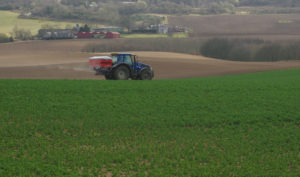 Fertiliser spreader in a field